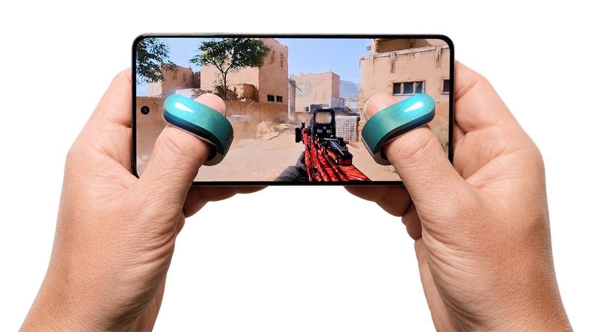 Hands holding a phone in FPS gameplay with teal Swipe Pads on the thumbs